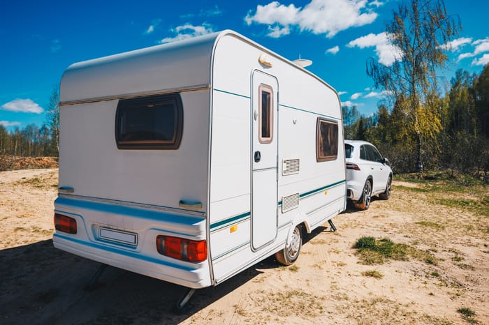 white-trailer-caravan-car-is-parked-on-the-side-of-road